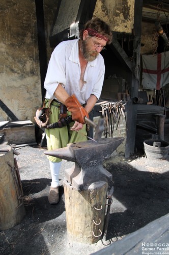 Blacksmith at work in the settlement.